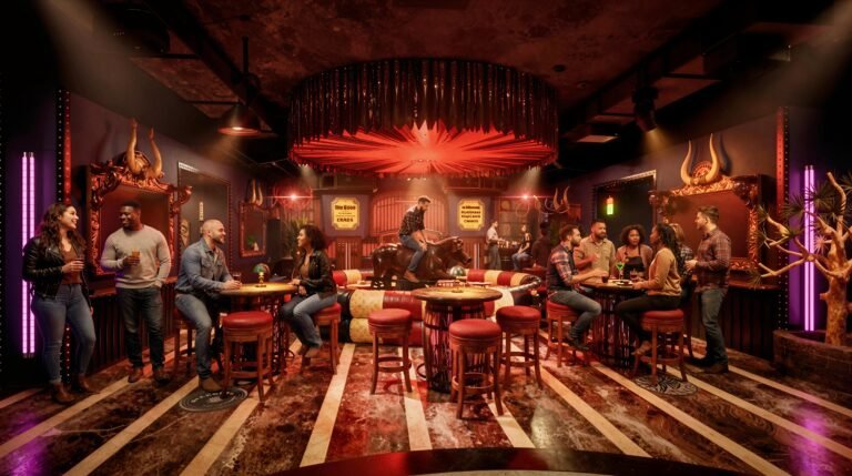 Lively underground bar party with diverse group around central table under red lights, surrounded by horns, mirrors, and neon signs.